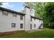 Rear exterior of a two-story home featuring painted brick and a chimney at 5414 Iris Sw Dr, Mableton, GA 30126