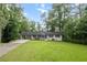 Charming single-story home with a long driveway and expansive green lawn at 5414 Iris Sw Dr, Mableton, GA 30126