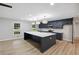 Modern kitchen featuring a large island with quartz countertops and stylish pendant lighting at 5414 Iris Sw Dr, Mableton, GA 30126
