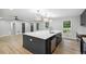 Bright kitchen features a large island, stainless steel appliances, and stylish pendant lighting at 5414 Iris Sw Dr, Mableton, GA 30126
