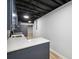 Basement kitchenette featuring white countertops, blue cabinets, and a stainless steel sink at 5414 Iris Sw Dr, Mableton, GA 30126