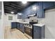 Finished basement kitchenette with modern appliances and blue cabinets and countertop at 5414 Iris Sw Dr, Mableton, GA 30126