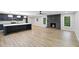 Open floor plan with a fireplace, new floors, and views into the kitchen at 5414 Iris Sw Dr, Mableton, GA 30126