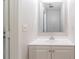 Clean half bathroom featuring a white vanity and a framed mirror at 5618 Stonington Trace Pkwy, Stone Mountain, GA 30087