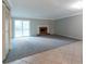 Open concept living room featuring a cozy fireplace and access to the outdoor patio at 5618 Stonington Trace Pkwy, Stone Mountain, GA 30087