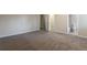 Spacious main bedroom with neutral carpeting and ensuite bathroom access at 5618 Stonington Trace Pkwy, Stone Mountain, GA 30087