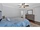 Bright bedroom featuring ceiling fan, neutral walls, wood floors, dresser, and a comfortable bed at 1261 Lavista Ne Rd # E-8, Atlanta, GA 30324