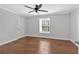 This bright bedroom features hard wood floors, white walls, and a window for natural light at 1261 Lavista Ne Rd # E-8, Atlanta, GA 30324