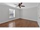 This bright bedroom features hard wood floors, white walls, and a window for natural light at 1261 Lavista Ne Rd # E-8, Atlanta, GA 30324