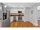 Modern kitchen featuring stainless steel appliances, white cabinets, backsplash, and hardwood floors at 1261 Lavista Ne Rd # E-8, Atlanta, GA 30324