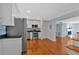 Modern open kitchen featuring stainless steel appliances, white cabinets, hardwood floors, and open floorplan at 1261 Lavista Ne Rd # E-8, Atlanta, GA 30324