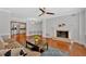 Spacious living room with a fireplace, hardwood floors, and a view into the kitchen at 1261 Lavista Ne Rd # E-8, Atlanta, GA 30324