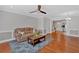 Bright living room featuring hardwood floors and open-concept design leading to the kitchen at 1261 Lavista Ne Rd # E-8, Atlanta, GA 30324