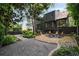 Charming backyard featuring a brick patio with outdoor seating and lush landscaping at 1860 Anjaco Nw Rd, Atlanta, GA 30309