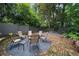 Private backyard seating area with brick detail and beautiful plantings at 1860 Anjaco Nw Rd, Atlanta, GA 30309