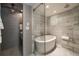 Elegant bathroom with marble tile, soaking tub, and modern fixtures at 1860 Anjaco Nw Rd, Atlanta, GA 30309