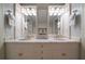 Bathroom featuring dual sinks, marble countertops and decorative mirrors at 1860 Anjaco Nw Rd, Atlanta, GA 30309