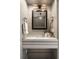 Chic powder room featuring a stylish vanity and decorative lighting at 1860 Anjaco Nw Rd, Atlanta, GA 30309