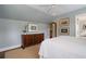 Cozy bedroom features natural light, beautiful dresser, and fresh white linens at 1860 Anjaco Nw Rd, Atlanta, GA 30309