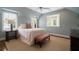 Comfortable bedroom features natural light, sitting bench and carpet flooring at 1860 Anjaco Nw Rd, Atlanta, GA 30309