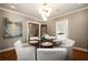 Elegant dining area with round table and seating, decorative lighting, and natural light at 1860 Anjaco Nw Rd, Atlanta, GA 30309