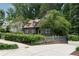 A charming house with well-maintained landscaping, mature trees, and a paved driveway at 1860 Anjaco Nw Rd, Atlanta, GA 30309