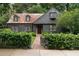 Charming home with brick walkway, gray wood fence and a neatly manicured green shrub border at 1860 Anjaco Nw Rd, Atlanta, GA 30309