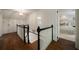 Hallway with wood floors leads to a staircase and a bedroom at 1860 Anjaco Nw Rd, Atlanta, GA 30309