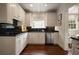 Kitchen featuring stainless steel appliances, dark countertops and hardwood floors at 1860 Anjaco Nw Rd, Atlanta, GA 30309