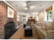 Living room with brick fireplace, plush seating, and natural light creates a cozy atmosphere at 1860 Anjaco Nw Rd, Atlanta, GA 30309