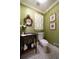 Traditional powder room with green wallpaper and a decorative mirror at 1860 Anjaco Nw Rd, Atlanta, GA 30309