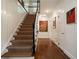 Hallway and staircase featuring hardwood floors, carpeted stairs, and white paneled walls at 1860 Anjaco Nw Rd, Atlanta, GA 30309