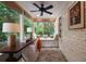 Charming sunroom features tile flooring, white brick walls, a window seat and a ceiling fan at 1860 Anjaco Nw Rd, Atlanta, GA 30309
