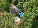 An aerial view showcasing a private pool, lush landscaping, and mature trees surrounding the property at 1036 Oxford Ne Rd, Atlanta, GA 30306