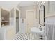 Bright bathroom with pedestal sink, shower, tile floor and built-in shelving at 1036 Oxford Ne Rd, Atlanta, GA 30306