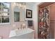 Well-lit bathroom featuring a modern vanity, decorative mirror, and a colorful shower curtain at 1036 Oxford Ne Rd, Atlanta, GA 30306