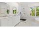 This bathroom features a double vanity, marble walk-in shower, and soaking tub at 1036 Oxford Ne Rd, Atlanta, GA 30306