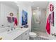 Stylish bathroom featuring modern fixtures, patterned tile, glass shower, and decorative art at 1036 Oxford Ne Rd, Atlanta, GA 30306