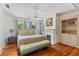 This bedroom has a ceiling fan, hardwood floors, and a fireplace at 1036 Oxford Ne Rd, Atlanta, GA 30306