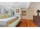Spacious main bedroom with hardwood floors, a ceiling fan, a fireplace and custom built-ins at 1036 Oxford Ne Rd, Atlanta, GA 30306