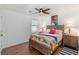 Comfortable bedroom with a ceiling fan, hardwood floors, and a bright window at 1036 Oxford Ne Rd, Atlanta, GA 30306