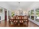 Elegant dining room with hardwood floors, a chandelier, and access to the outdoor patio at 1036 Oxford Ne Rd, Atlanta, GA 30306