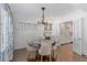 Elegant dining room with chandelier and a built-in bar, seamlessly connected to the kitchen through glass doors at 1036 Oxford Ne Rd, Atlanta, GA 30306