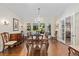 Formal dining room featuring a vintage chandelier, wood floors, and large windows providing natural light at 1036 Oxford Ne Rd, Atlanta, GA 30306