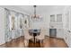 Charming dining room with chandelier, stained glass window, hardwood floors, and built in wine storage at 1036 Oxford Ne Rd, Atlanta, GA 30306