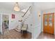 Welcoming foyer featuring hardwood floors, a staircase, and a charming, patterned wooden entry door at 1036 Oxford Ne Rd, Atlanta, GA 30306