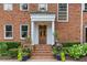 Charming front entrance with stately columns, a wooden door, and beautifully arranged potted plants at 1036 Oxford Ne Rd, Atlanta, GA 30306