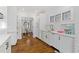 Bright white kitchen with stainless appliances, marble counters, and dining area access for easy entertaining at 1036 Oxford Ne Rd, Atlanta, GA 30306