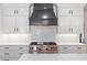 This gourmet kitchen boasts a professional range, a decorative backsplash, and sleek white cabinets with modern hardware at 1036 Oxford Ne Rd, Atlanta, GA 30306
