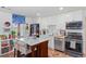 Modern kitchen featuring an island, white cabinets, stainless steel appliances, and hardwood floors at 1036 Oxford Ne Rd, Atlanta, GA 30306